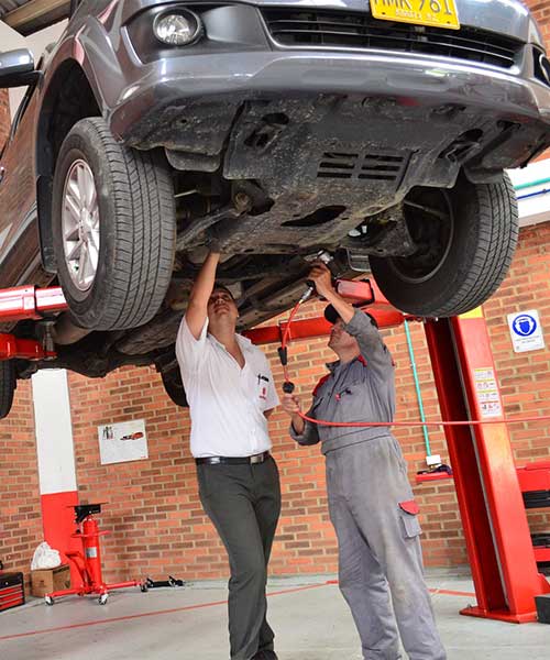 two men looking at a car